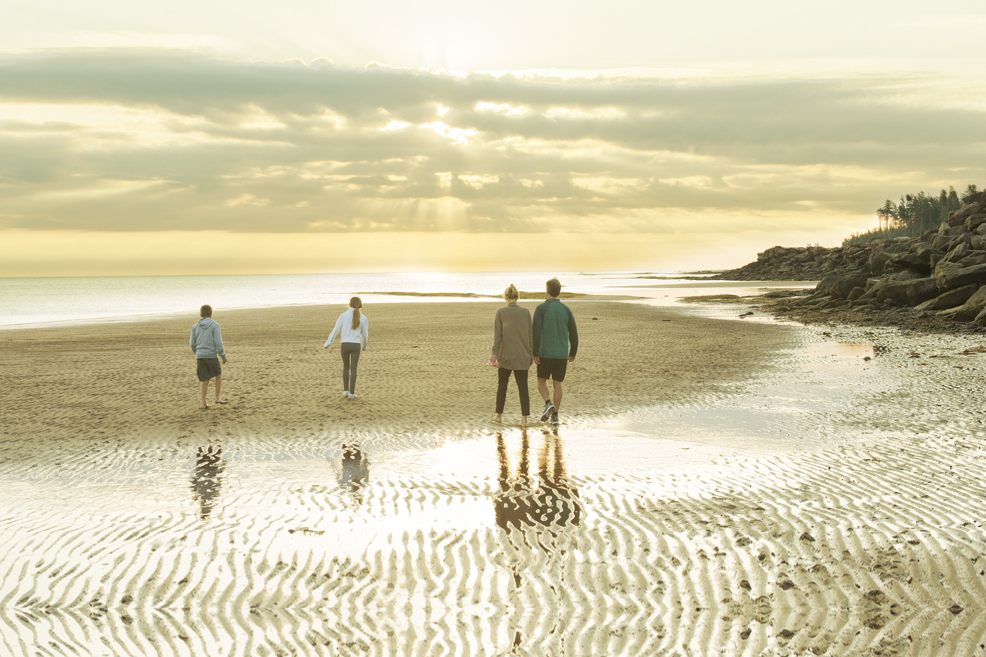 Family on the beach at Fox Harb'r Resort